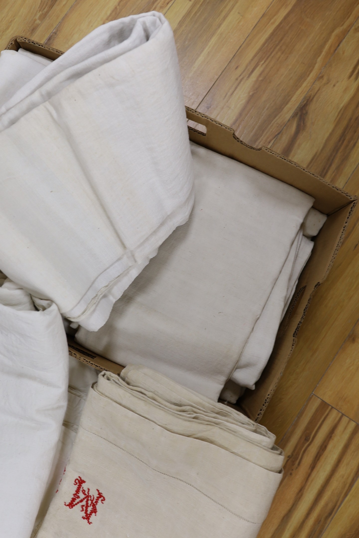 Two boxes of French Provincial linen sheets, some with red monograms